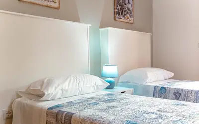 Letto o letti in una camera di Casa Baddò, fronte spiaggia Air Con IUN R1866