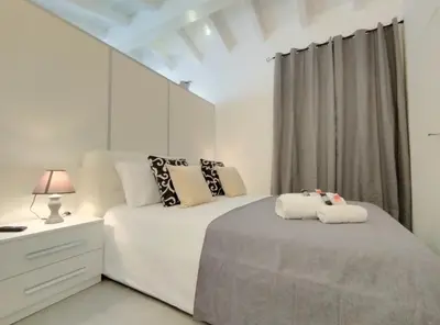 Letto o letti in una camera di Holmann Suite & Rooms