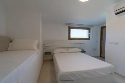 Letto o letti in una camera di THE BEACH