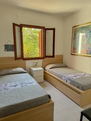 Letto o letti in una camera di Comoda villetta con giardino
