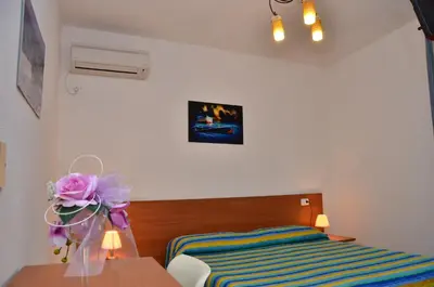 Letto o letti in una camera di Domo - Guest-House Il Nespolo Fiorito