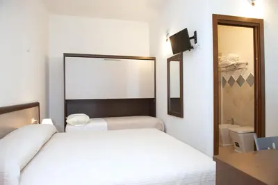 Letto o letti in una camera di Domo - Guest-House Il Nespolo Fiorito
