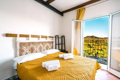 Letto o letti in una camera di CAMERA VISTA MARE CASA RAIMONDA Ammentos Posada