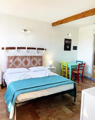 Letto o letti in una camera di LOFT CON USO CUCINA E TERRAZZO PANORAMICO - FORA E' MUROS II - Ammentos Posada