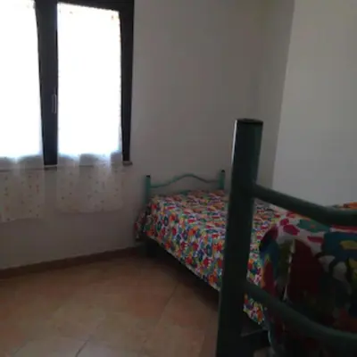 Letto o letti in una camera di Villetta con giardino e posto auto