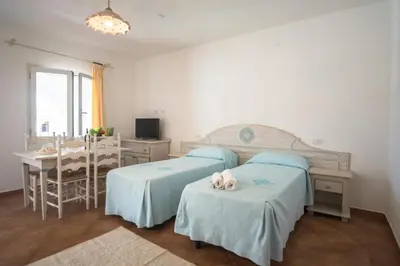 Letto o letti in una camera di Superb Le Residenze del Golfo di Orosei num2192