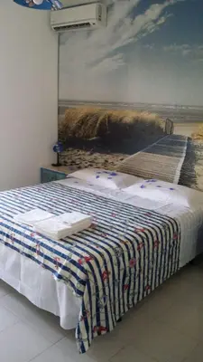 Letto o letti in una camera di Casa Sara San Teodoro