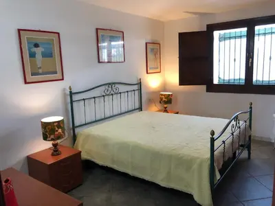 Letto o letti in una camera di Villetta Arborea Vista Mare