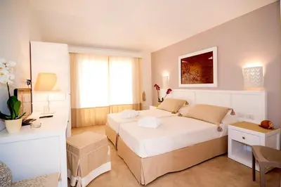 Letto o letti in una camera di Stella Marina Budoni