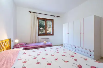 Letto o letti in una camera di CASA AGRUSTOS PANORAMICA