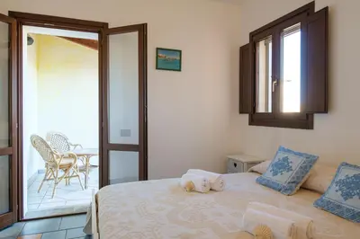 Letto o letti in una camera di [Incantevole Villetta]con Giardino e Vista mare