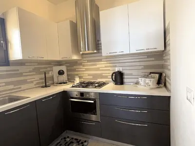 Cucina o angolo cottura di PUNTA EST QUADRILOCALE TERRAZZA FAVOLOSA VISTA MARE