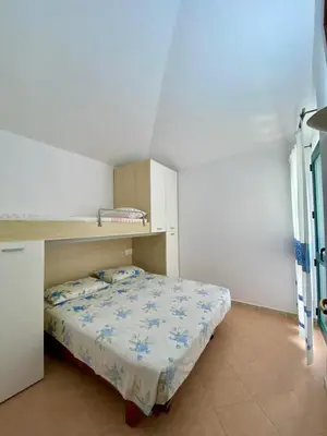 Letto o letti in una camera di Villetta a Tanaunella