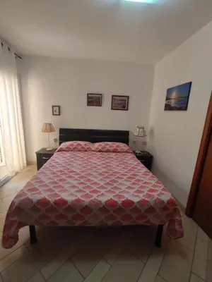 Letto o letti in una camera di MONOLOCALE WENGE'