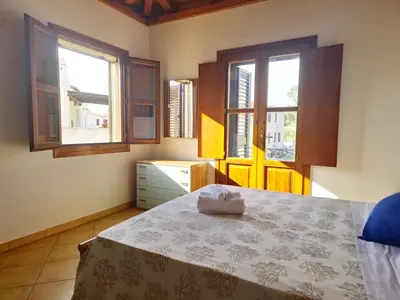 Letto o letti in una camera di Mikè House- Appartamento con balcone a Sos Alinos