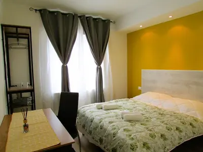 Letto o letti in una camera di Casa Ribes Rooms, l'angolo tranquillo alle porte della città