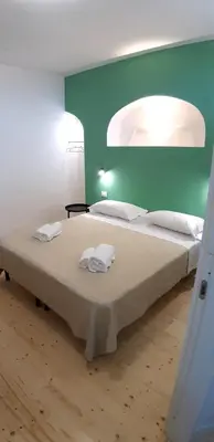 Letto o letti in una camera di Casa Ribes Rooms, l'angolo tranquillo alle porte della città