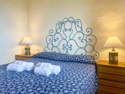 Letto o letti in una camera di Punta Est Quadrilocale Vista Mare
