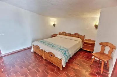 Letto o letti in una camera di HOTEL Al FARO , SPIAGGIA LA CINTA ,SAN TEODORO