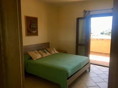 Letto o letti in una camera di La Perlacea fronte mare