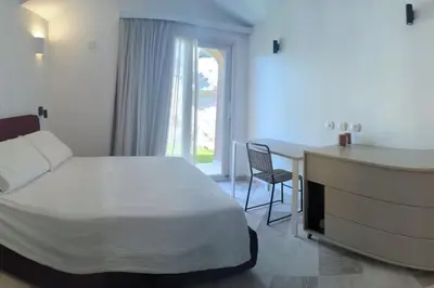 Letto o letti in una camera di Supreme Beach Location with pool at Cala Sassari
