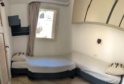 Letto o letti in una camera di Supreme Beach Location with pool at Cala Sassari
