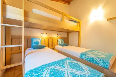 Letto o letti in una camera di Le Giuggiole di Punta Molara
