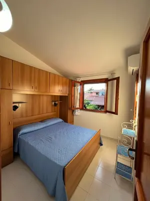 Letto o letti in una camera di Villetta MP casa sviluppata su due piani con doppia veranda e parcheggio privato