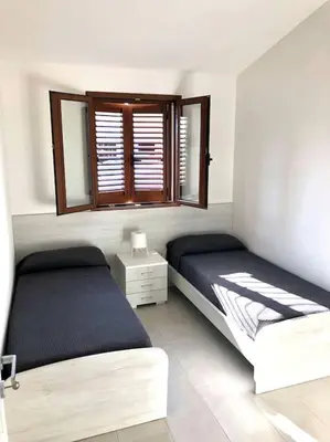 Letto o letti in una camera di La perla sul mare della Caletta