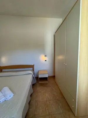 Letto o letti in una camera di Case vacanza Corallo - San Teodoro centro