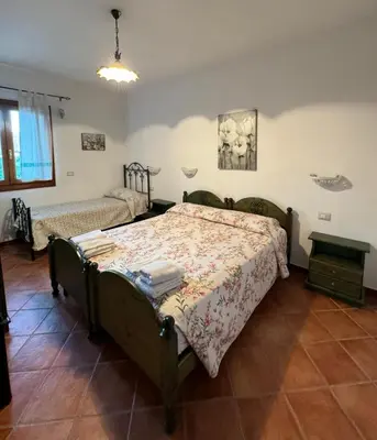 Letto o letti in una camera di B&B Il Glicine