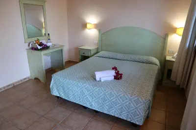 Letto o letti in una camera di Club Esse Cala Gonone