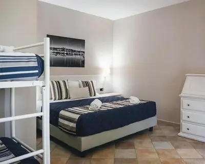Letto o letti in una camera di Zeta Club San Teodoro Le Rose