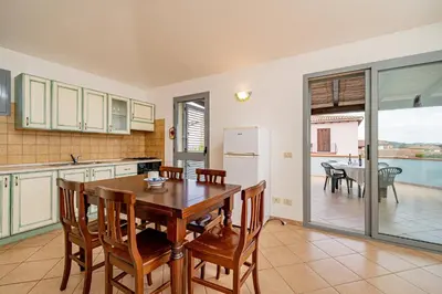Cucina o angolo cottura di ISA-Residence with swimming-pool in Cala Girgolu, apartments with private outdoor area