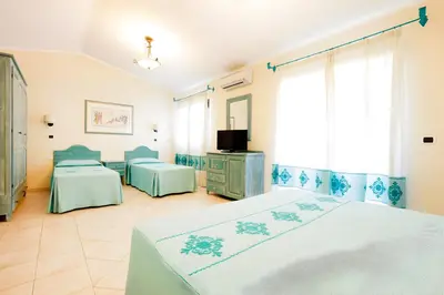 Letto o letti in una camera di Hotiday Golfo Aranci