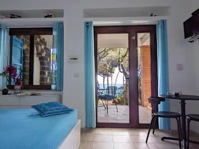 Letto o letti in una camera di Ferienzimmer Ginepro am Meer