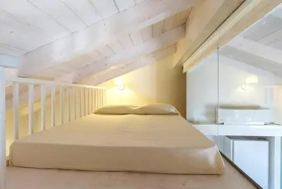 Letto o letti in una camera di Villa con accesso privato alla spiaggia di Cala Brandinchi - 8 posti letto
