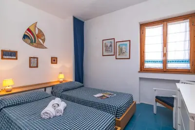 Letto o letti in una camera di Piazzetta Trilo Porto 30m From The Beach - Happy Rentals
