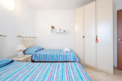 Letto o letti in una camera di Cozy veranda retreat near Budoni