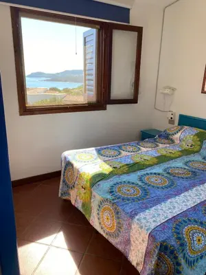 Letto o letti in una camera di villa Punta Molara with beautiful view