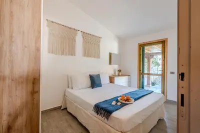 Letto o letti in una camera di 5min dalla Spiaggia La Cinta - Villetta Elegante a San Teodoro