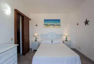 Letto o letti in una camera di HH San Teodoro vista Mare