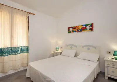 Letto o letti in una camera di HH San Teodoro vista Mare