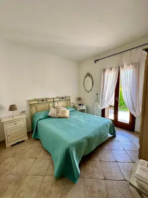 Letto o letti in una camera di Ca' Mirto, una villa vicino a spiagge da sogno