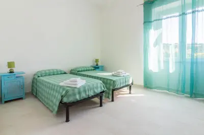 Letto o letti in una camera di GuestHost Peaceful stay in Berchiddeddu with garden