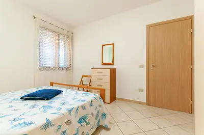 Letto o letti in una camera di Appartamento Salvatore Caletta sul mare