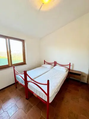 Letto o letti in una camera di Trilocale a 900mt dalla Spiaggia La Cinta