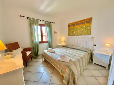 Letto o letti in una camera di Luxury apartment Ginepro sea view with common swimming pool just 50 mt from the beach