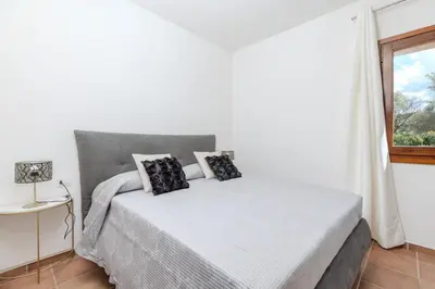 Letto o letti in una camera di SPLENDIDO APPARTAMENTO SAN TEODORO La Suaredda
