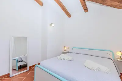 Letto o letti in una camera di Villa Due Mari Coda Cavallo